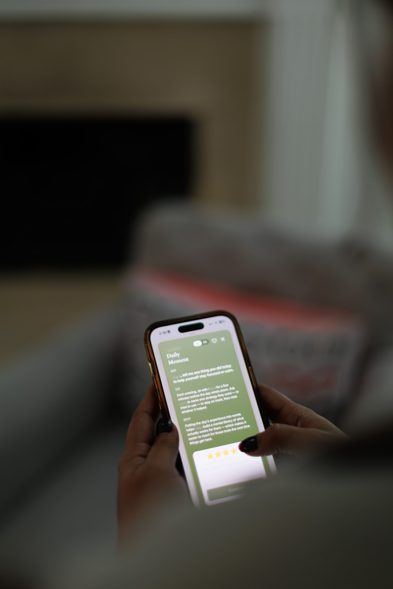 A caregiver reading a SayWell Daily Moment on her phone.